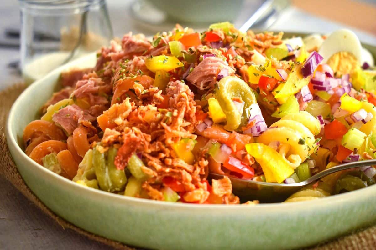 Tuna pasta salad in bowl with spoon.