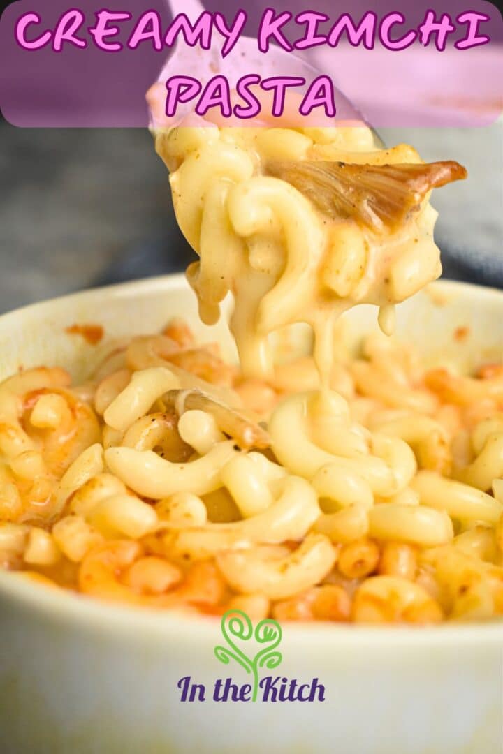 Kimchi mac and cheese in a bowl and on a spoon with text overlay that says 'creamy kimchi pasta'.