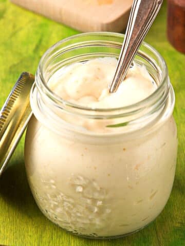 Lime sauce in jar with spoon.
