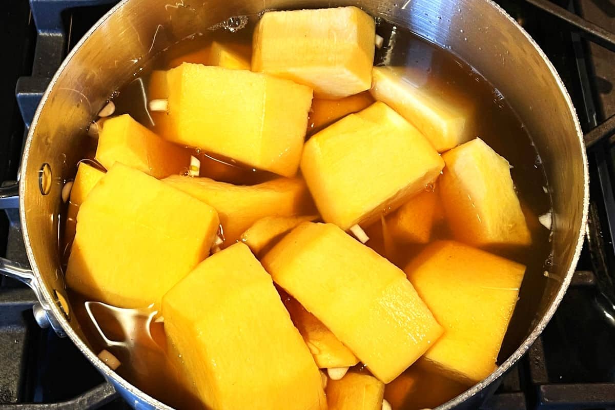 Pumpkin and broth in pot.