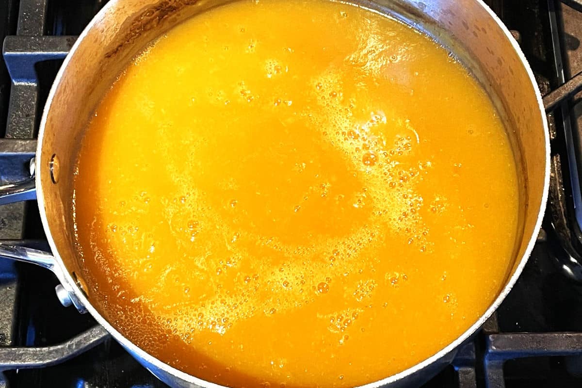 Pumpkin soup blended in pot.