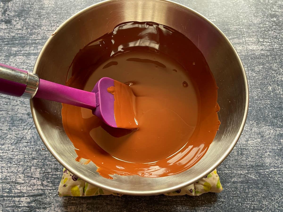 Melted chocolate in bowl with spatula.