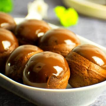 Chocolate covered donut holes on serving tray.