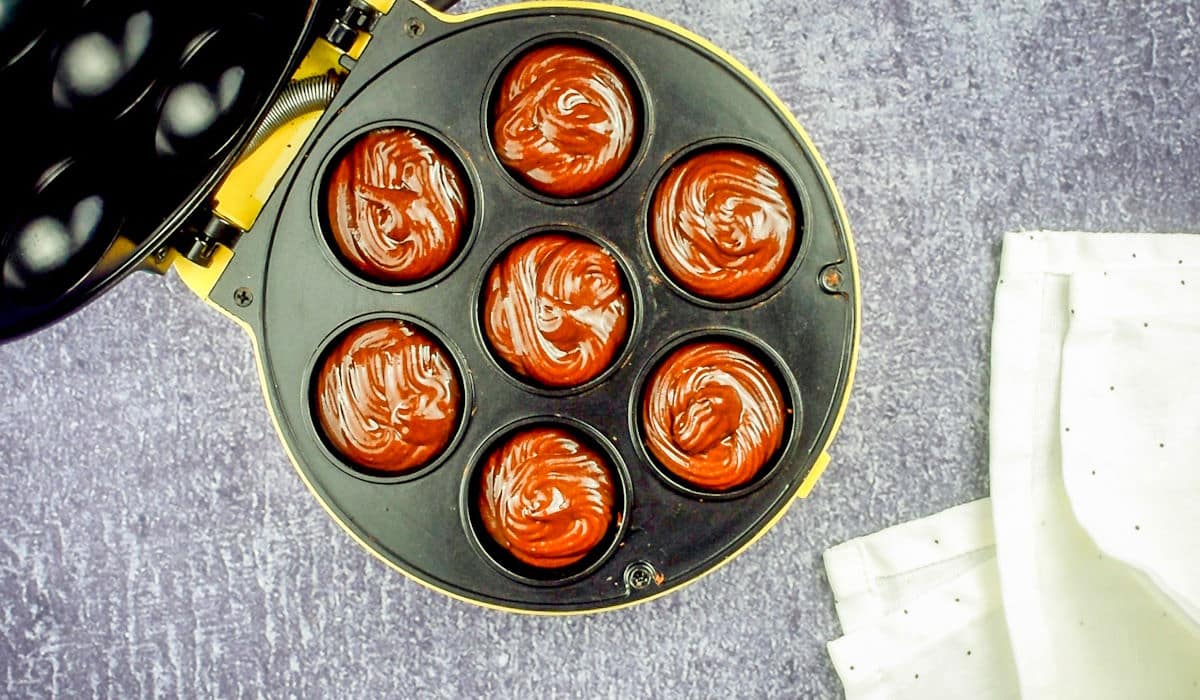 Donut hole batter in cake pop maker holes.