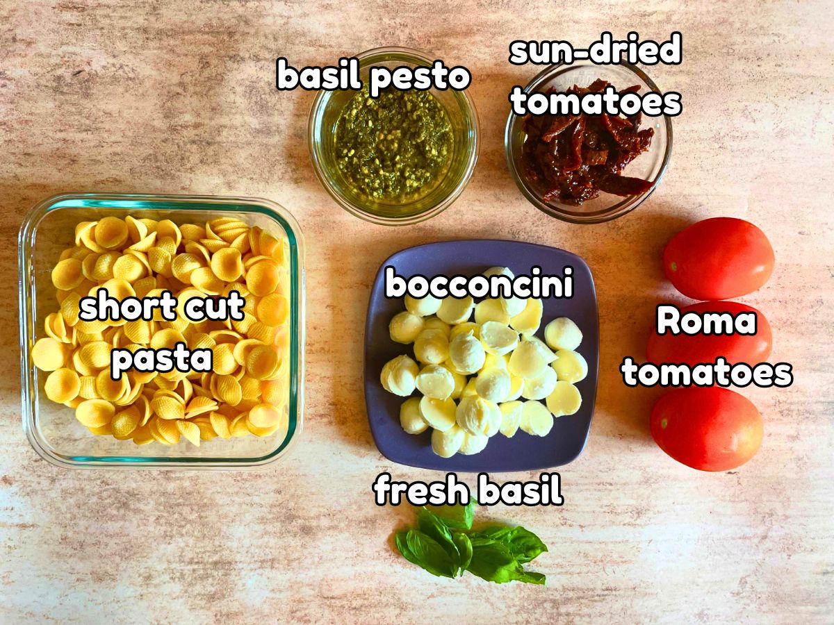 Caprese pasta salad ingredients labeled.