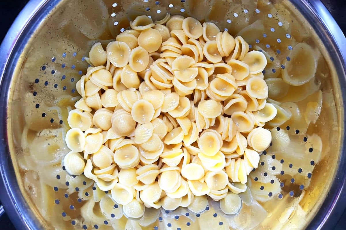 Orecchiette pasta in metal colander.