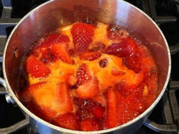 Strawberry compote mixture in saucepan with cornstarch.