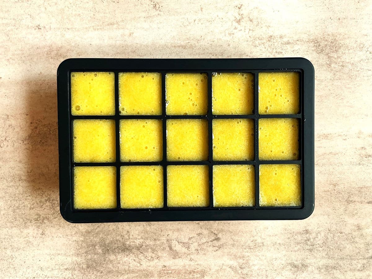 Peach purée in ice cube tray.