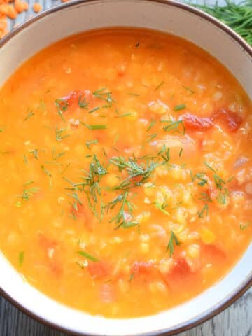 Red lentil and dill soup in bowl.