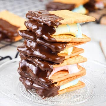 Skillet s'mores with colored marshmallows stacked on plate.