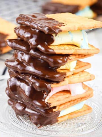 Skillet s'mores with colored marshmallows stacked on plate.