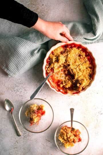 Strawberry crumble in tart dish and dessert bowls.