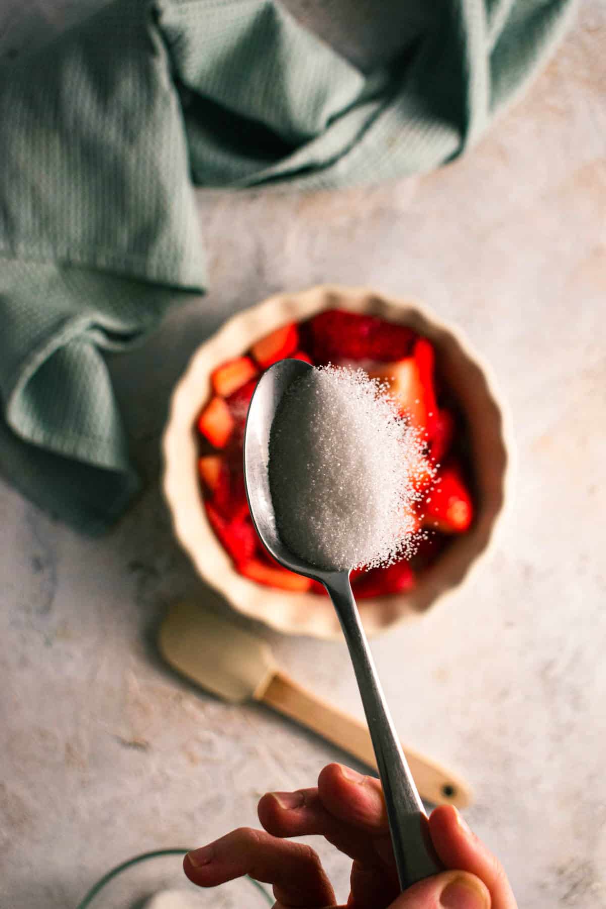 Strawberries and sugar in tart dish.