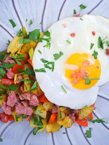 Electric skillet breakfast sausage and egg hash on plate.