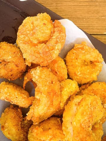 Coconut shrimp on parchment paper.