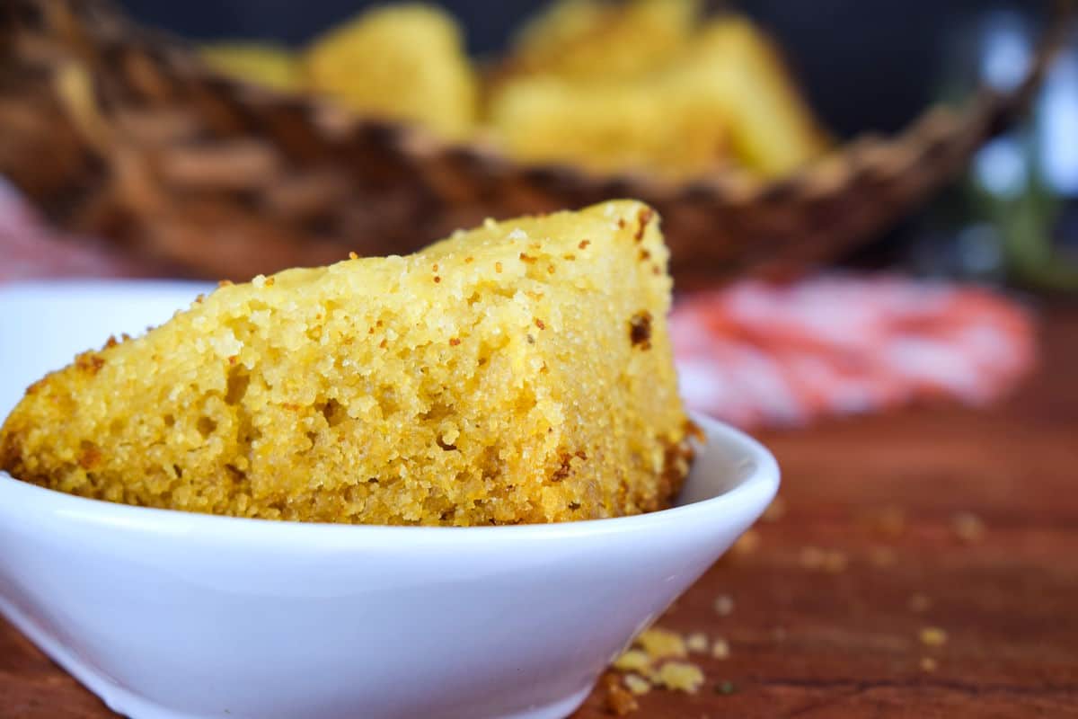Piece of electric skillet cornbread in white dish.