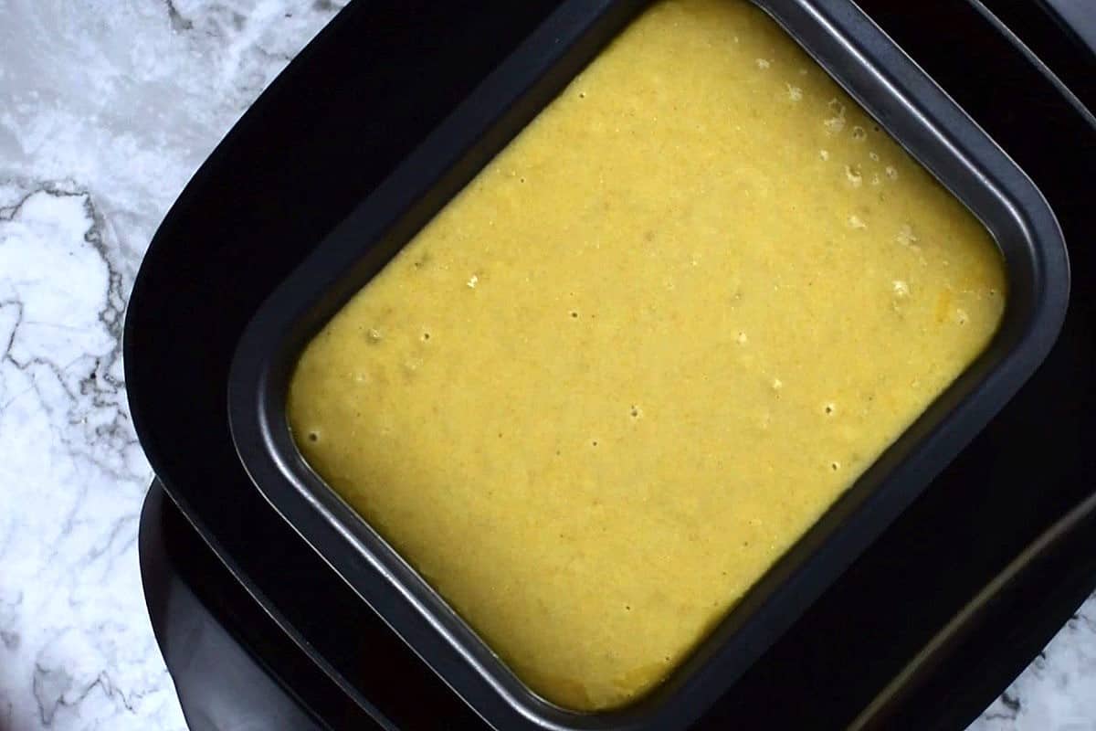 Cornbread batter in pan in electric skillet.