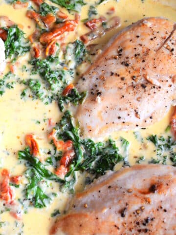 Creamy Tuscan chicken breast in skillet.