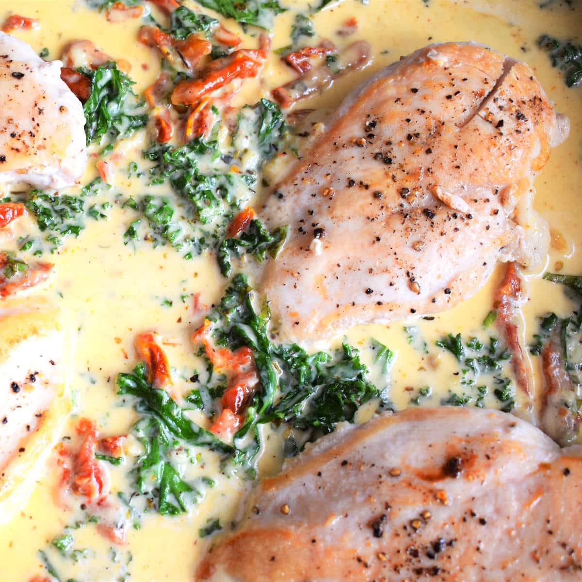 Creamy Tuscan chicken breast in skillet.