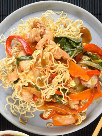 Crunchy chow mein noodle dish on white plate.