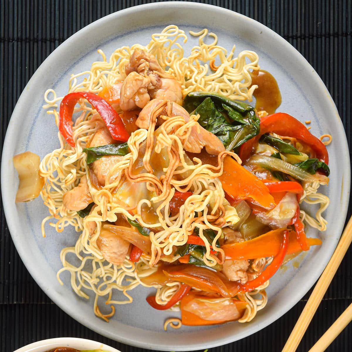Crunchy chow mein noodle dish on white plate.