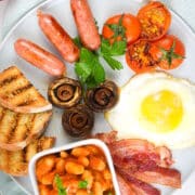 Full English breakfast on white plate.