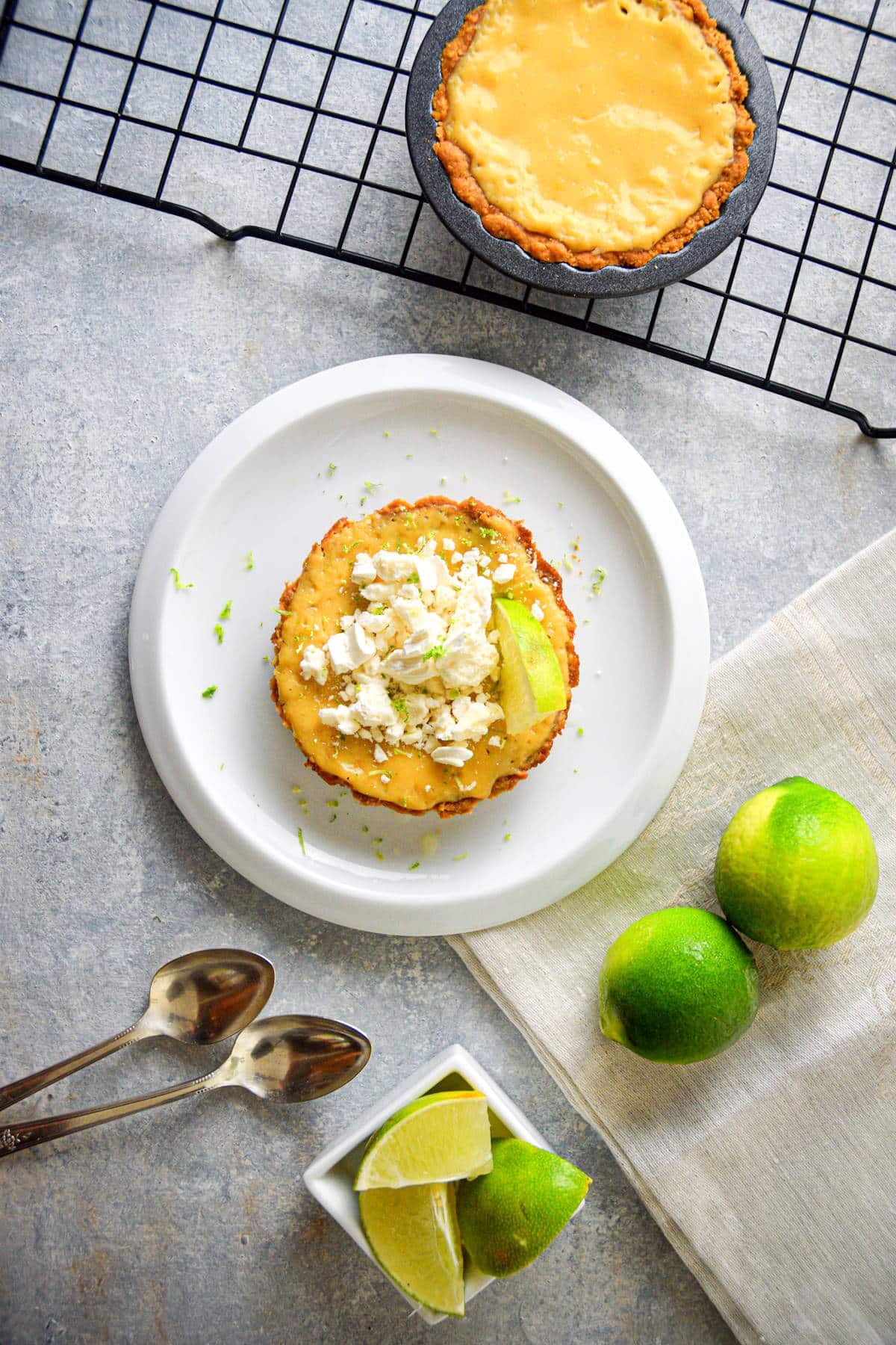 Mini electric skillet key lime pies on plate and baking rack.