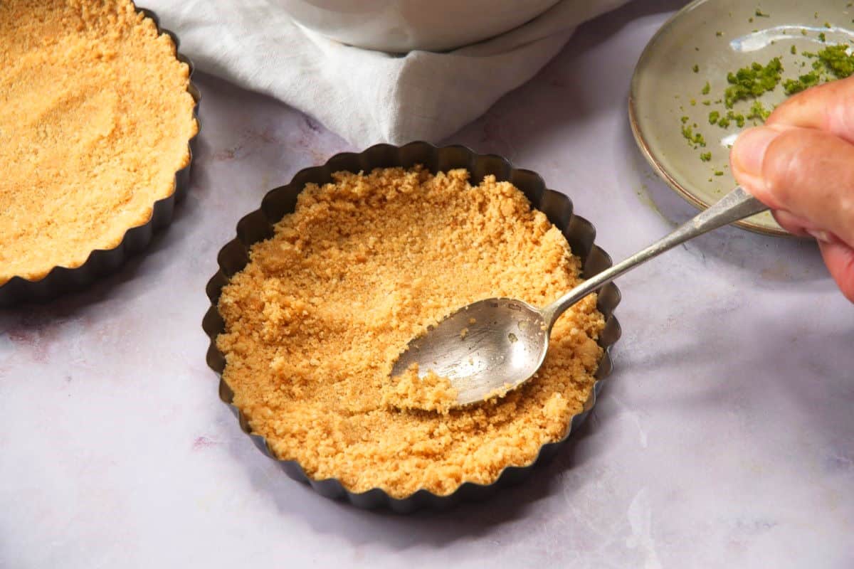 Graham cracker crust in mini tart pans.