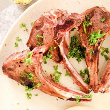 Lamb chops on plate.