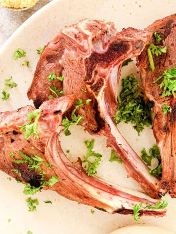 Lamb chops on plate.