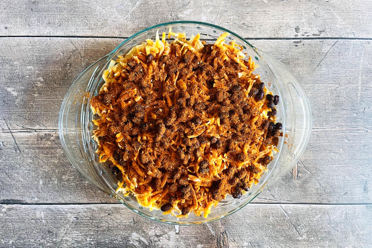 Nachos ingredients in pie dish.
