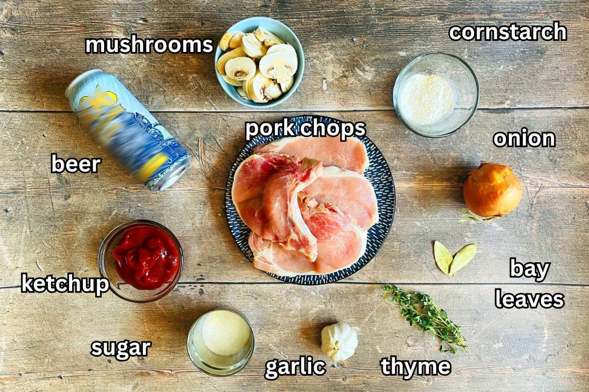 Electric skillet pork chops ingredients prepped and labeled on wooden background.