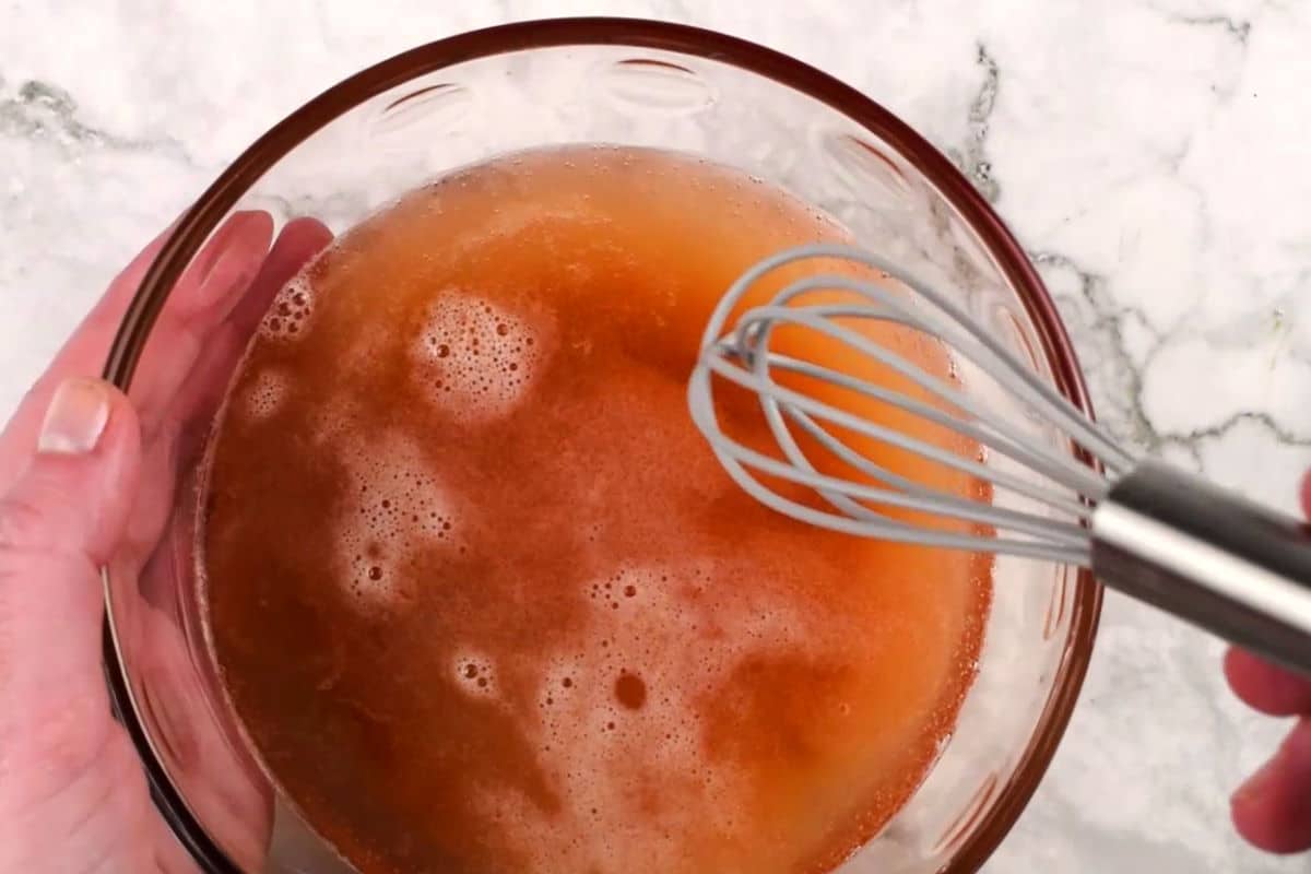 Beer gravy in bowl with whisk.