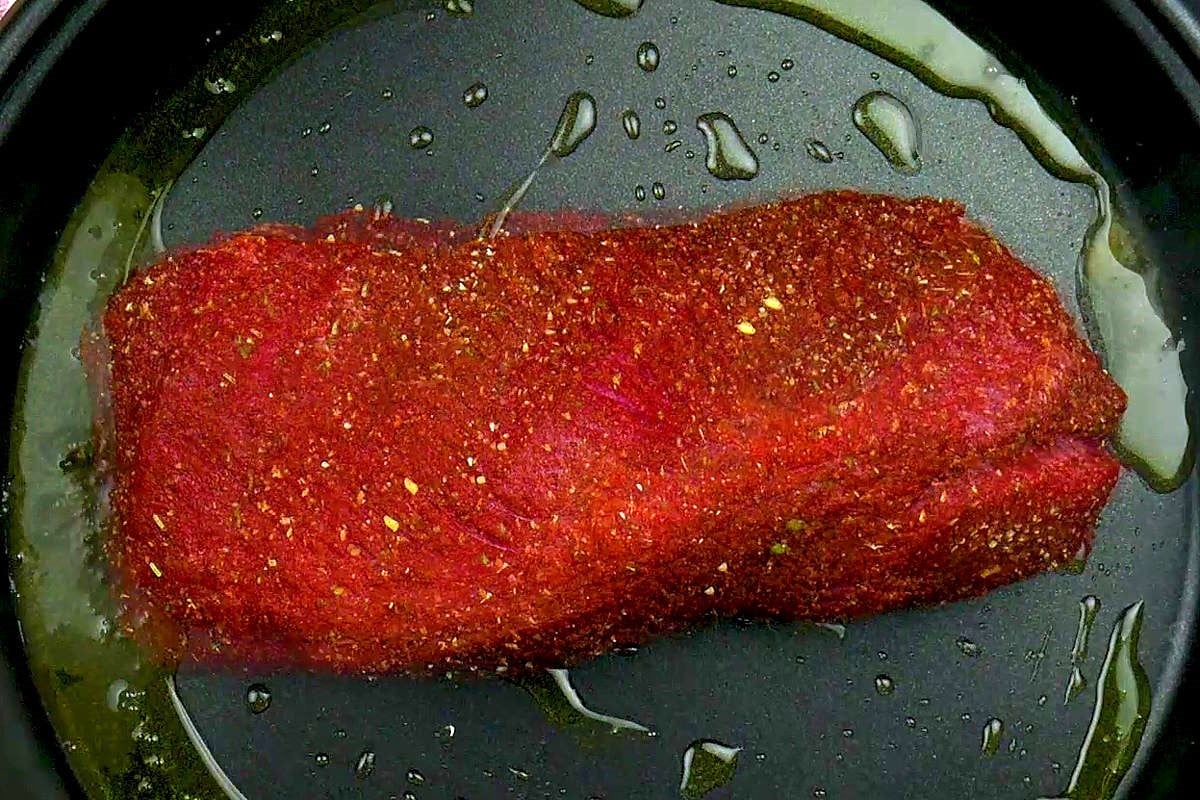 Raw pot roast in electric frying pan.