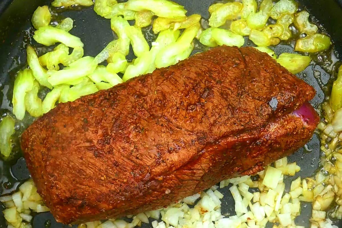 Pot roast cooking in electric skillet.