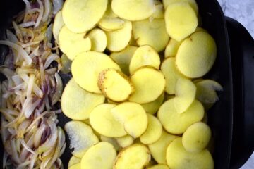 Potatoes and onions in an electric skillet.