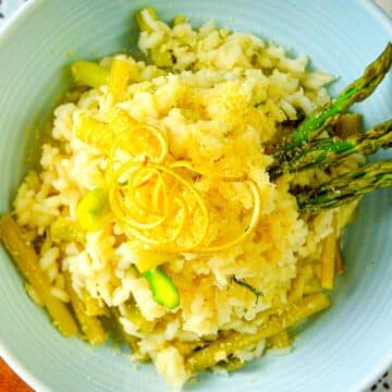 Risotto in bowl with asparagus and lemon zest.