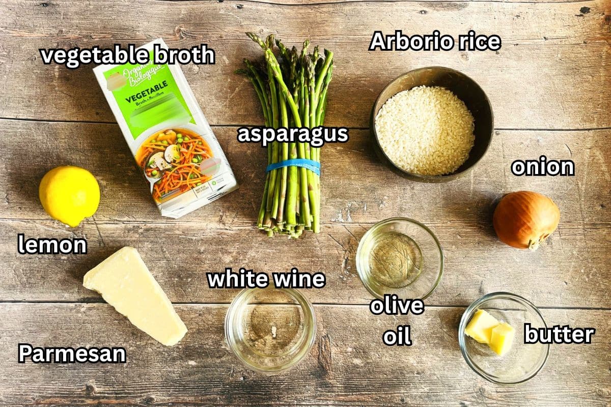 Electric skillet asparagus risotto ingredients labeled on wooden background.
