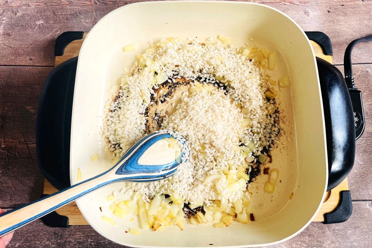 Rice and onion in electric skillet.