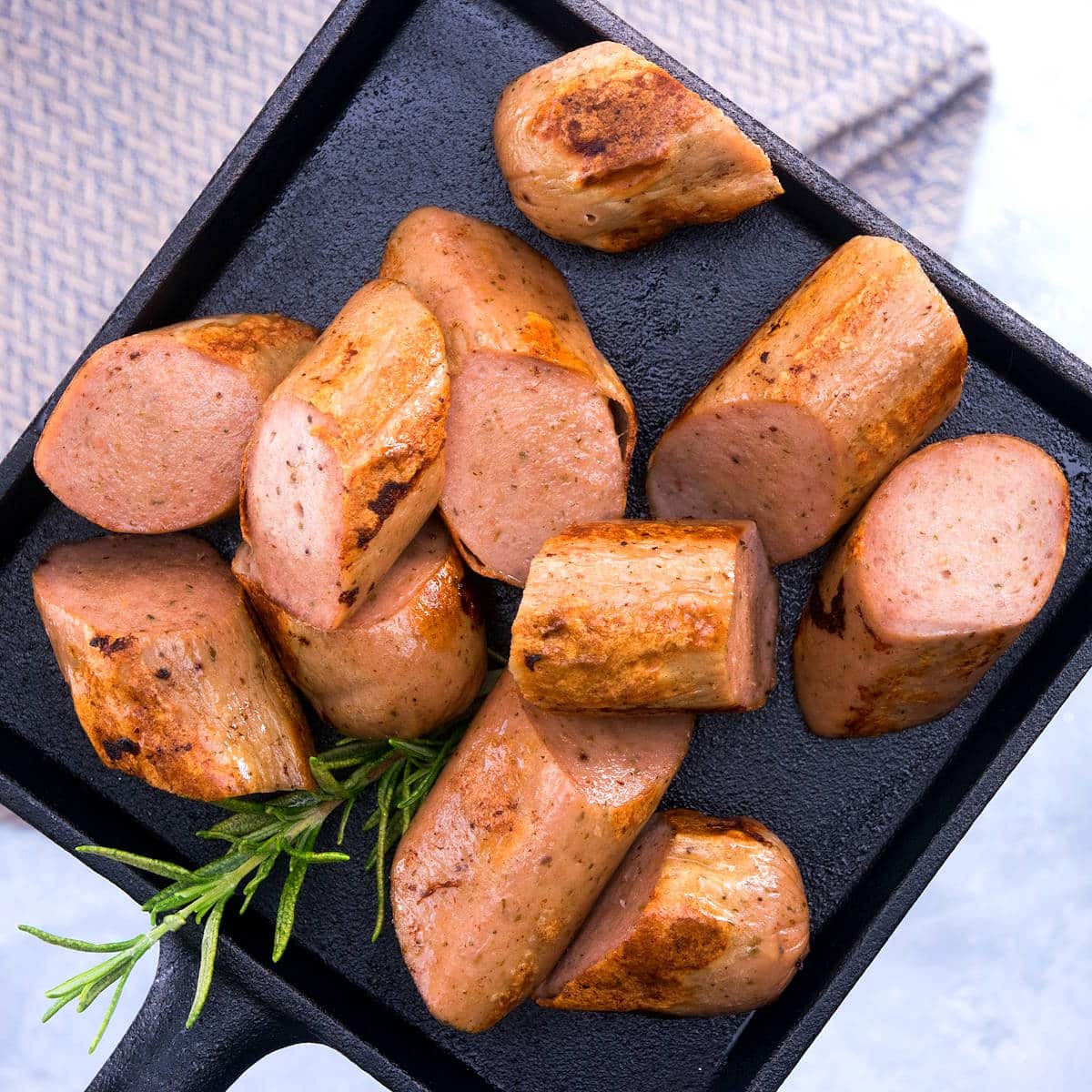 Sausage sliced on a small cast iron tray.