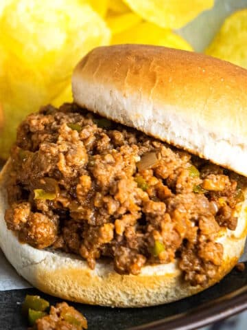 Sloppy Joe with chips in the background.