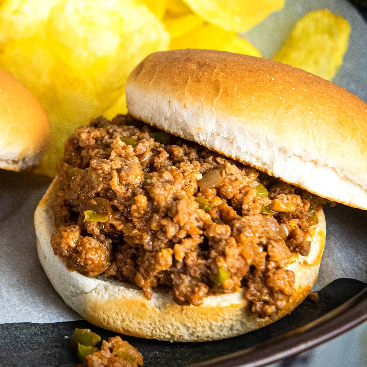 Sloppy Joe with chips in the background.