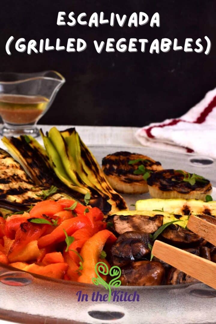 Grilled vegetables on plate on black background with text overlay that says 'escalivada (grilled vegetables)'.