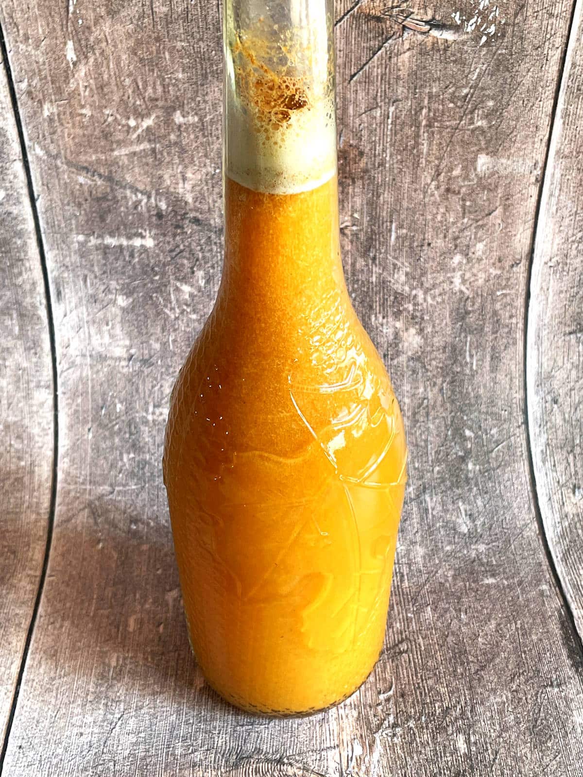Fall pumpkin party punch in a fall-themed glass bottle.