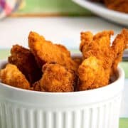 Golden fish sticks in ramekin.