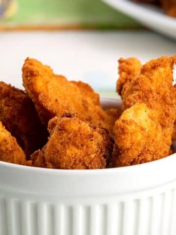 Golden fish sticks in ramekin.