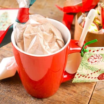 Chocolate mug cake mix in a red mug with Christmas gift label.