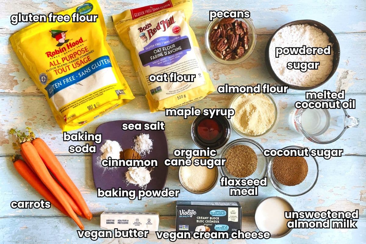 Gluten free vegan carrot cupcakes ingredients labeled on blue wooden background.
