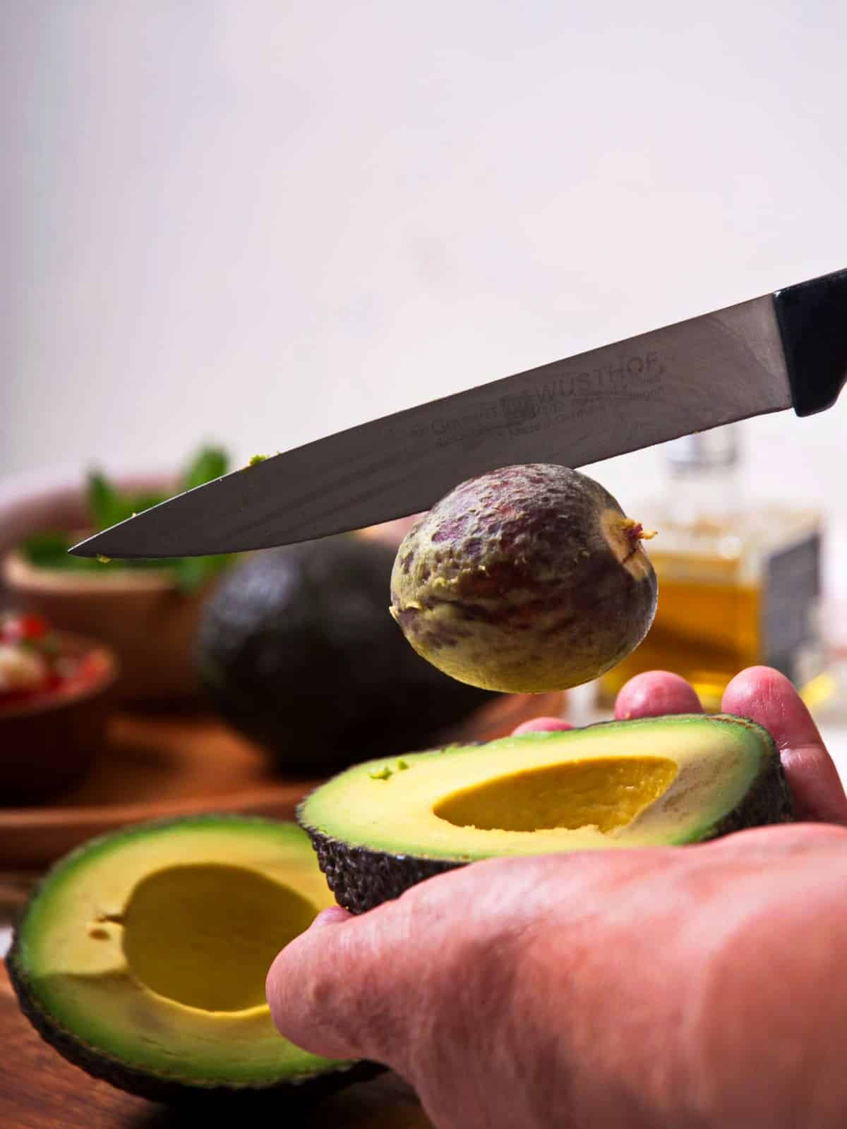 Avocado pit removed with knife.