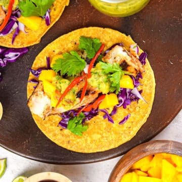 Grilled halibut tacos on brown serving tray.